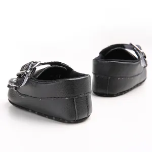 Rear view detail of black baby walker shoes with soft sole and metallic buckle