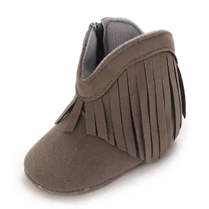 Close-up of infant brown suede tassel booties with soft sole and side zipper closure