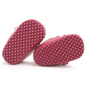 Close-up view of the non-slip polka dot soft sole on baby walking shoes