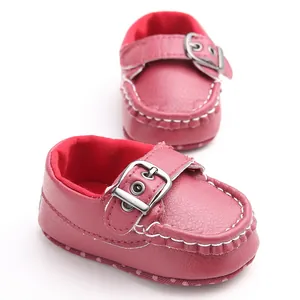 Close-up of stylish pink baby walking shoes with soft soles and buckle straps for infants