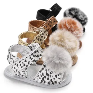 Assortment of baby leopard print sandals with fuzzy pom-poms for infants