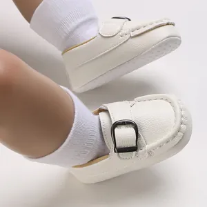 Macro view of white soft-soled infant walking shoes with stylish buckle detail for babies