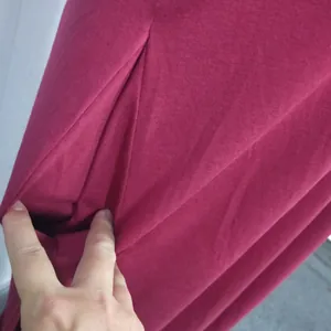 Close-up detail of the functional side pocket on a solid burgundy casual maxi dress