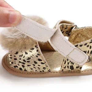 Macro view of leopard print baby toddler shoe with velcro closure and soft fur ball detail