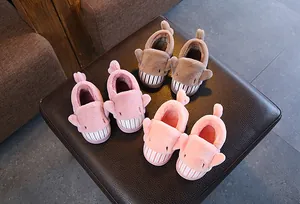 Top view of cute children's cartoon shark plush slippers in multiple soft colors