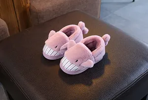 Detailed view of cute pink fuzzy cartoon slippers for kids with warm lining
