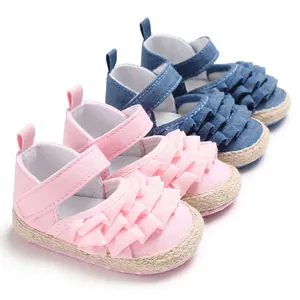 Detail view of pink and denim blue ruffled soft-sole walker shoes for baby girls