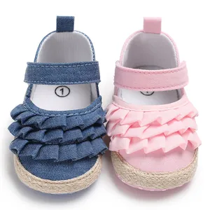 Close-up of ruffled layers and woven sole on baby girl soft-sole Mary Jane shoes.