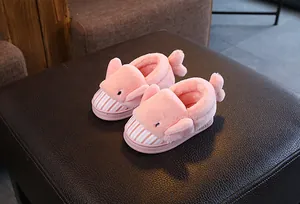 Detail view of cute pink cartoon shark plush slippers for kids winter indoor warmth