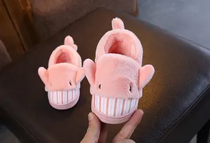Detail of cute pink cartoon whale plush slippers for kids with soft warm lining