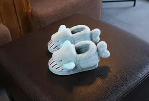 Detailed macro view of cute light blue plush shark slippers for kids with striped toe design