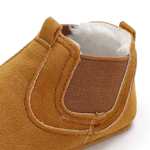 Close-up of warm fleece lining inside tan suede baby winter walker boots.