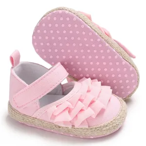 Close-up detail of baby girl pink princess ruffle shoes with anti-slip soft dotted sole