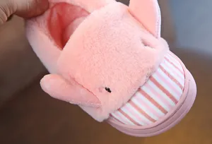 Close-up of soft pink plush texture and cartoon elephant ears on children's slipper