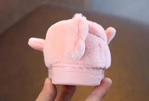Detailed back view of pink plush cartoon slippers for kids with soft fur texture