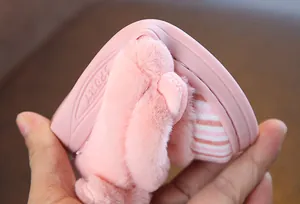 Close-up of flexible pink sole on plush cartoon kids winter slippers