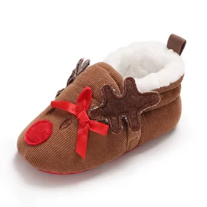 Detailed close-up of reindeer themed baby winter shoes with soft white fleece lining