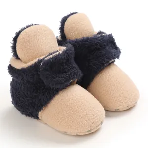 Primer plano de botas de nieve para bebé con forro polar en azul marino y beige