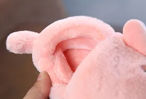 Detailed close-up view of the soft pink plush lining on children's winter slippers