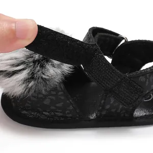 Close-up detail of infant leopard print sandal showing adjustable hook-and-loop strap