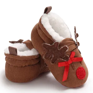 Detailed view of brown corduroy reindeer baby shoes with cozy white faux fur lining