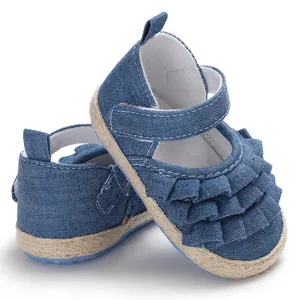 Close-up shot of blue denim baby girl princess shoes with tiered ruffled layers