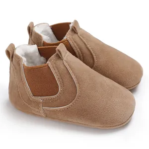 Close-up detail of brown suede baby winter walking shoes featuring soft warm white fur lining.