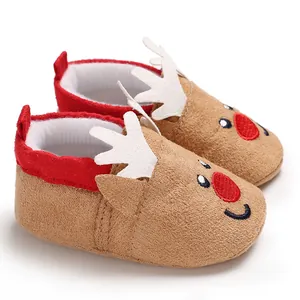 Close-up of adorable reindeer baby winter walker shoes with antlers and red nose