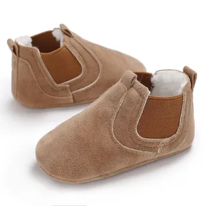 Macro detail of tan baby winter walking boots with warm faux fur lining and elastic sides
