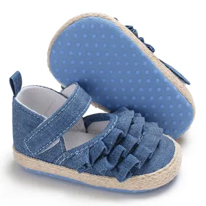 Detail view of blue denim baby walking shoes with ruffle design and non-slip sole