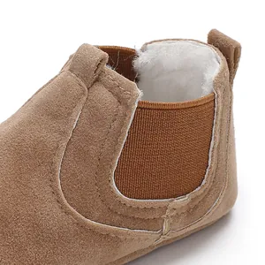 Close-up of warm faux fur lining and elastic side panel on tan baby winter boots