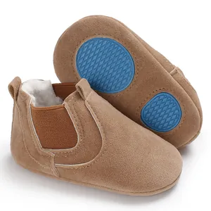 Detail of tan suede baby walking shoes with warm faux fur lining and blue non-slip soles