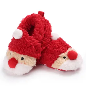 Detailed view of plush red Santa Claus baby winter booties with soft fuzzy texture