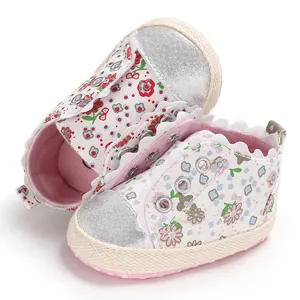 Detailed view of floral print baby girl pre-walker shoes with silver toe cap