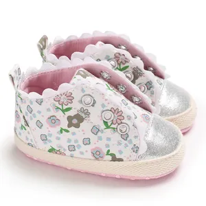 Close-up of baby girl floral shoes with silver glitter toe and scalloped lace trim