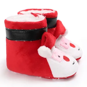 Detail of red Santa Claus baby winter boots with soft plush lining and cute face design