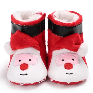 Detailed view of red plush Santa Claus baby boots with faux fur lining