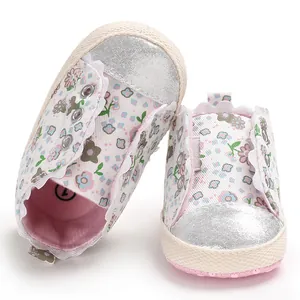 Detail view of pink floral baby girl walking shoes with soft soles and silver toes