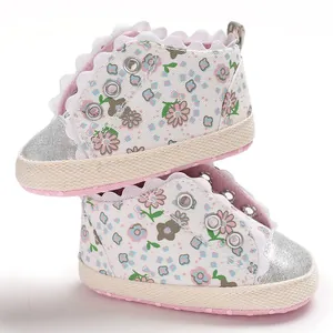 Close-up of floral print baby princess shoes with silver glitter toe and soft pink soles