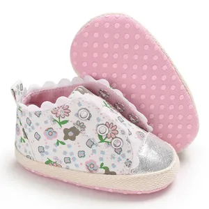 Detail view of floral baby girl walking shoes with anti-slip pink polka dot soft sole