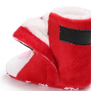 Detail of red plush baby Christmas boots showing velcro strap and fleece lining