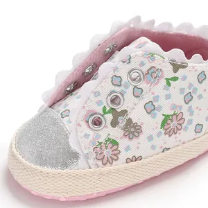 Close-up of floral print baby girl walker shoe with delicate lace trim and soft sole.