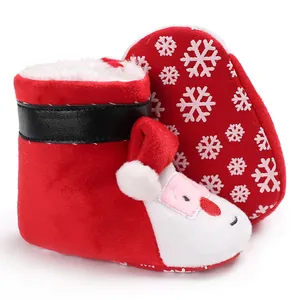 Detailed view of red plush Santa Claus baby winter boots with snowflake soles