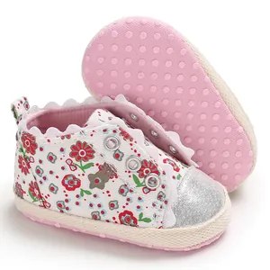 Close-up detail of baby girl floral pre-walker shoes with pink soft non-slip soles.