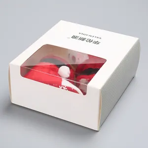 Christmas themed plush baby shoes in a white windowed gift box packaging