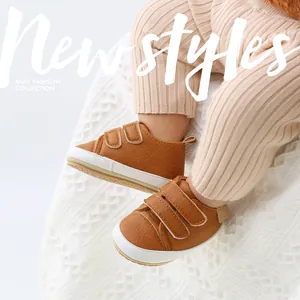 Detailed macro shot of brown faux leather baby shoes with velcro straps