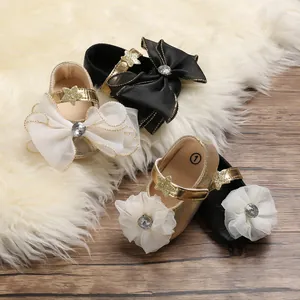 Detailed view of baby princess walking shoes featuring large mesh bows and flower accents