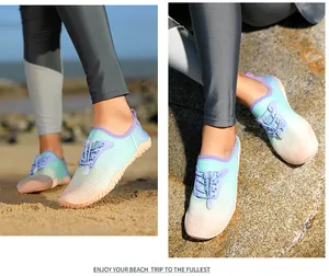 Detailed view of quick-dry water shoes worn by a model on beach sand and rocks