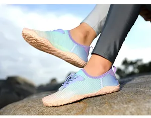 Close-up of quick-dry water shoes with non-slip soles on a rocky outdoor terrain