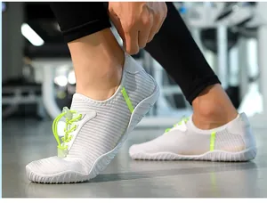 Close-up action shot of white quick-dry water shoes with neon green details on feet